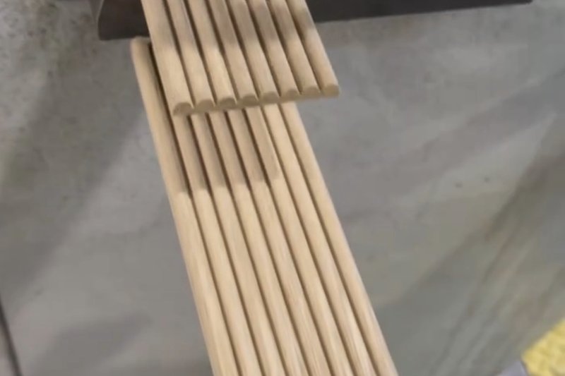 Freshly milled fluted wood moulding profiles coming off the shaper