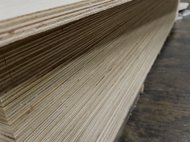 Close-up edge detail of stacked plywood sheets showing ply layers